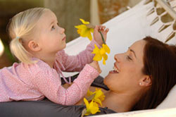 A young girl playing with her mother