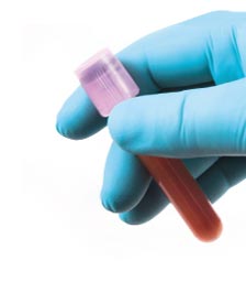 Gloved hand with test tube